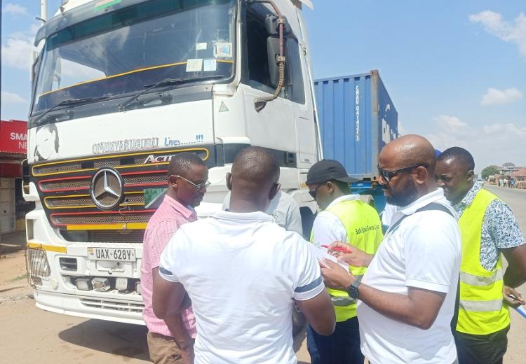  The RSS multidisciplinary Survey team interview a truck driver parked along the highway at Naluwerere, Uganda.